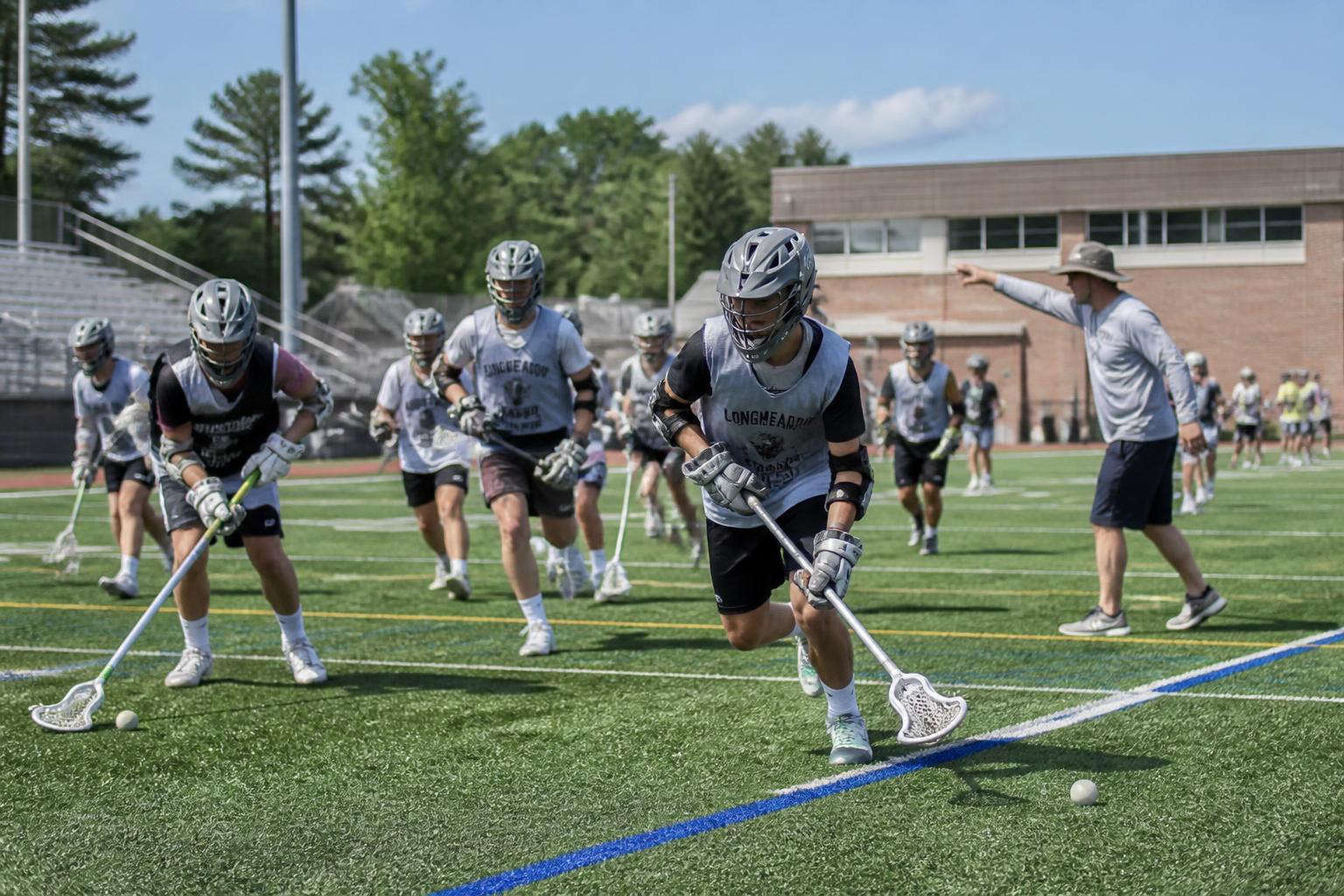 High school lacrosse players running a stick-skills drill